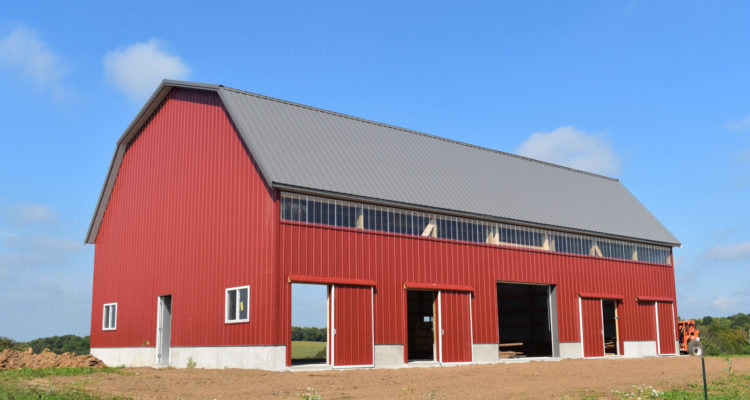 New,Red,Barn,Constructed,On,A,Farm,In,Summer,With